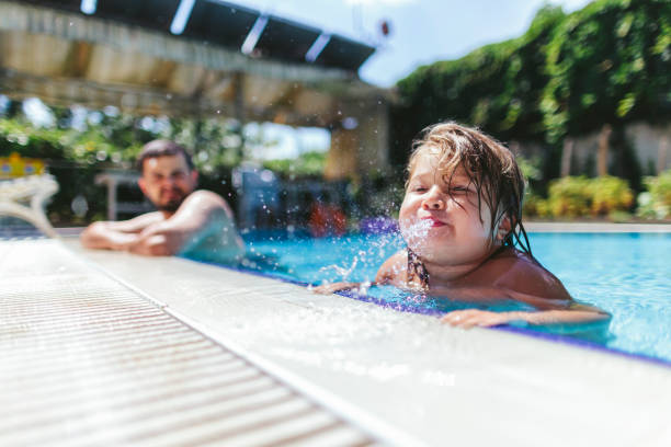 istock Father and small daughter enjoying in pool 1029304688
