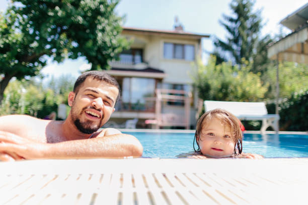 istock Father and small daughter enjoying in pool 1029304722