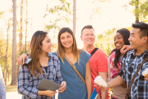 istock College student friends share digital tablet on university campus. 1029308328