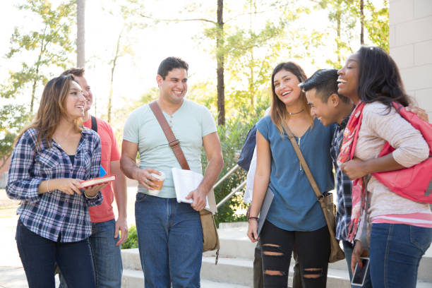 istock College student friends share digital tablet on university campus. 1029308354