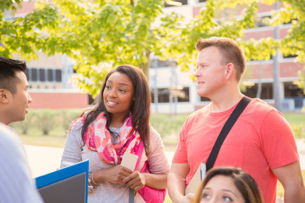 istock College student friends talk together on university campus. 1029308424