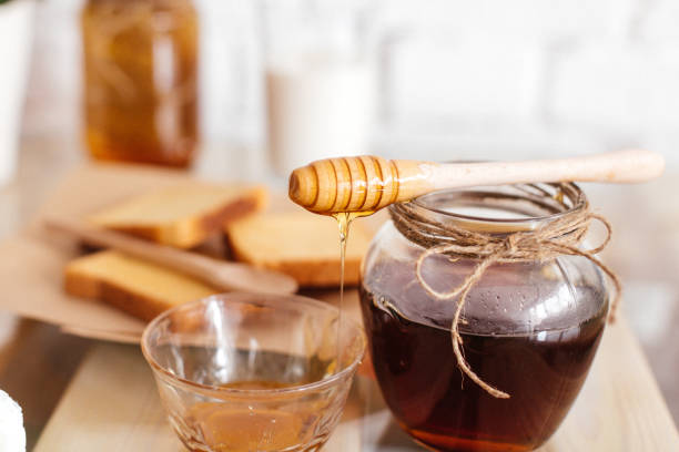 istock Honey with Honeycombs in a Jar 1029310882
