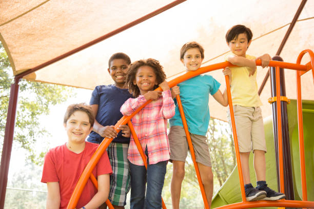 istock Multi-ethnic group of school children playing on school playground. 1029316740