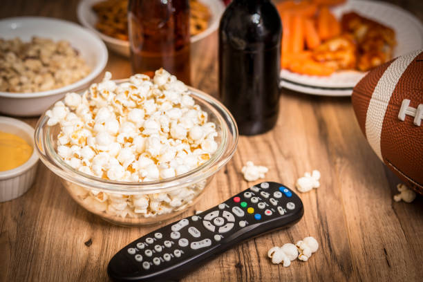 istock Watching the football game with snacks, drinks. 1029316834