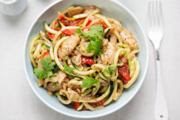 istock Stir fry chilli & coriander soya chunks with spiralled courgette spaghetti and semi dried tomatoes 1029317422