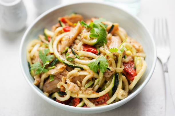istock Stir fry chilli & coriander soya chunks with spiralled courgette spaghetti and semi dried tomatoes 1029317424