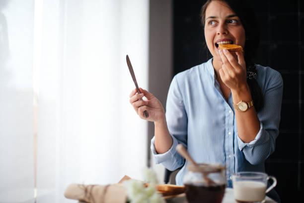 istock Woman eating honey on toasted bread 1029319776