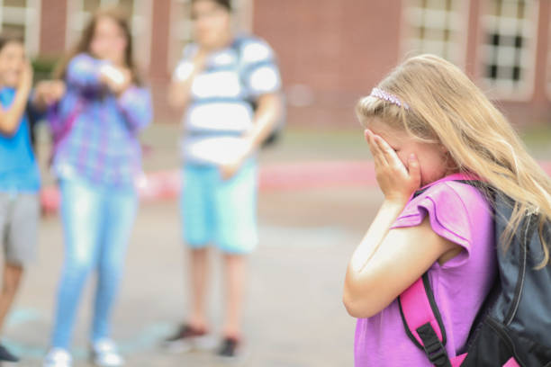 istock Elementary age girl being bullied at school. 1029319870