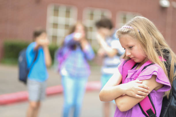 istock Elementary age girl being bullied at school. 1029319940