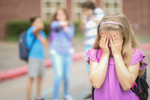 istock Elementary age girl being bullied at school. 1029319986