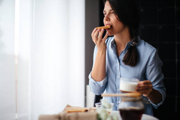 istock Woman eating honey on toasted bread 1029320030