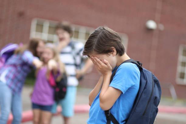 istock Elementary age boy being bullied at school. 1029320088