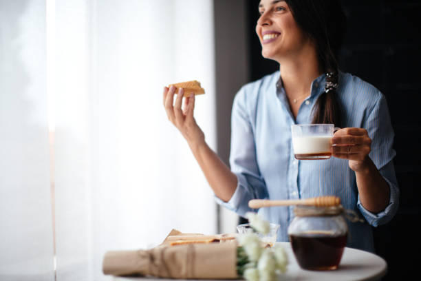 istock Woman preparing breakfast milk and honey 1029320420