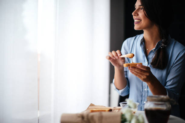 istock Woman preparing breakfast milk and honey 1029320566