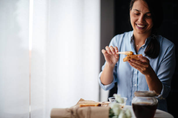 istock Woman preparing breakfast milk and honey 1029320718