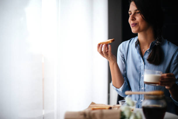 istock Woman preparing breakfast milk and honey 1029322896
