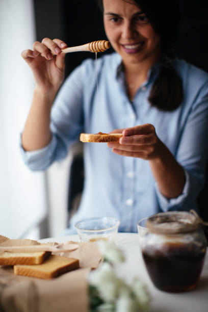 istock Woman preparing breakfast milk and honey 1029323136