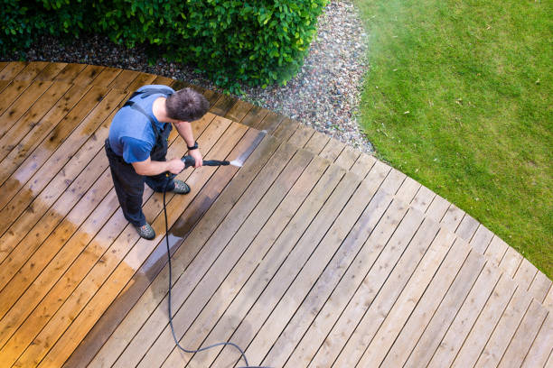 man cleaning terrace with a power washer - high water pressure cleaner on wooden terrace surface man cleaning terrace with a power washer - high water pressure cleaner on wooden terrace surface terraced field stock pictures, royalty-free photos & images