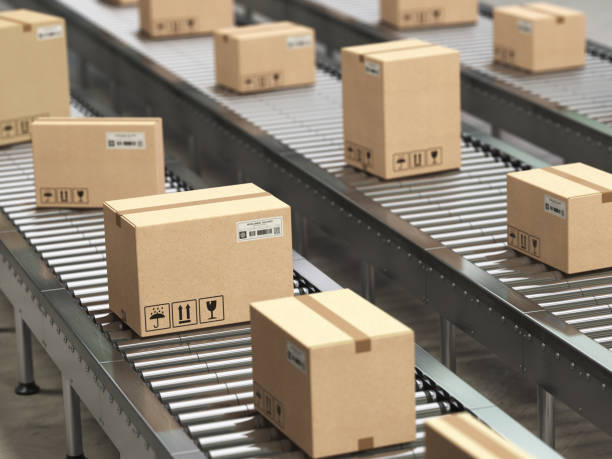 istock Cardboard boxes on conveyor roller in distribution warehouse, Delivery and packaging service concept. 1029329040