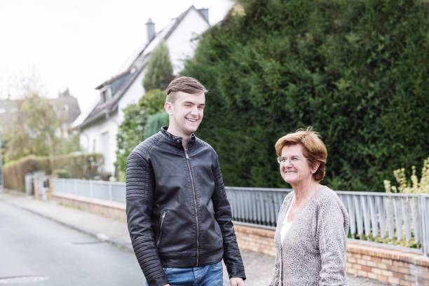 istock Happy Grandmother Standing With Grandson On Road 1029332012