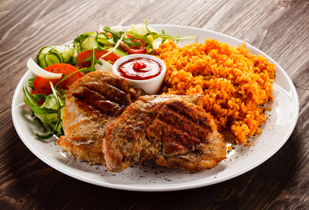 istock Grilled steaks with groats and vegetables 1029332848