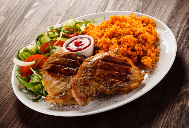 istock Grilled steaks with groats and vegetables 1029333358