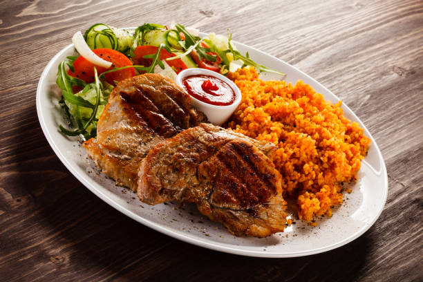 istock Grilled steaks with groats and vegetables 1029333838