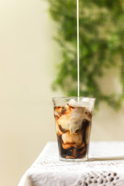 istock Iced coffee black coffee pouring the milk 1029334510