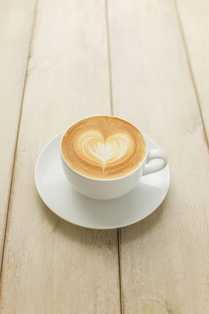 istock Hot coffee latte isolated on wooden table 1029334638