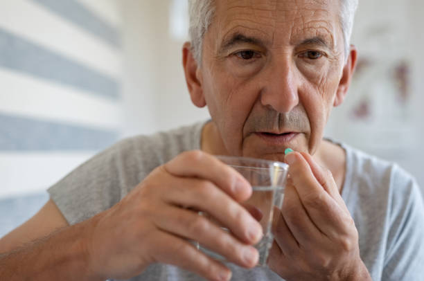 istock Senior man taking medicine 1029339812