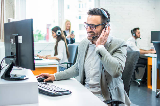istock Friendly service agent talking to customer in call centre 1029339880