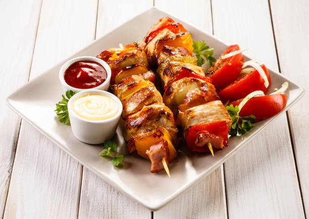istock Kebabs - grilled meat and vegetables on wooden background 1029342964