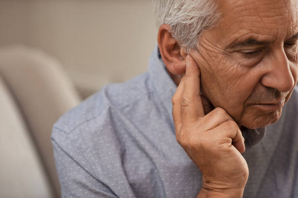 senior man with hearing problems - portrait men senior adult depression imagens e fotografias de stock