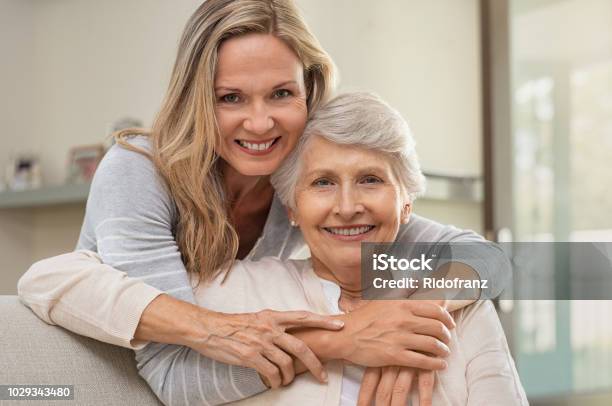 Woman Hugging Mother With Love Stock Photo - Download Image Now - Daughter, Mother, Senior Adult