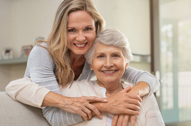 woman hugging mother with love - grandparent senior adult senior women multi generation family imagens e fotografias de stock