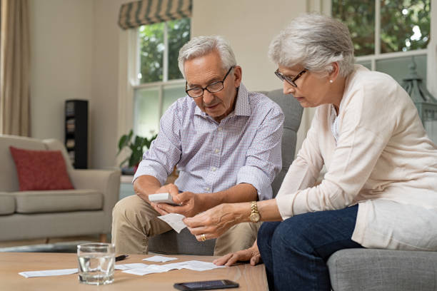 istock Senior couple calculating expenses 1029344000