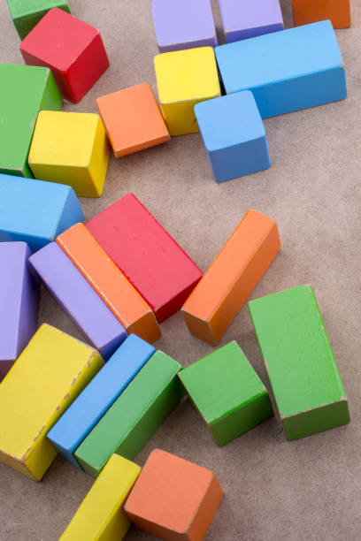 istock Colorful building  blocks on brown background 1029344994