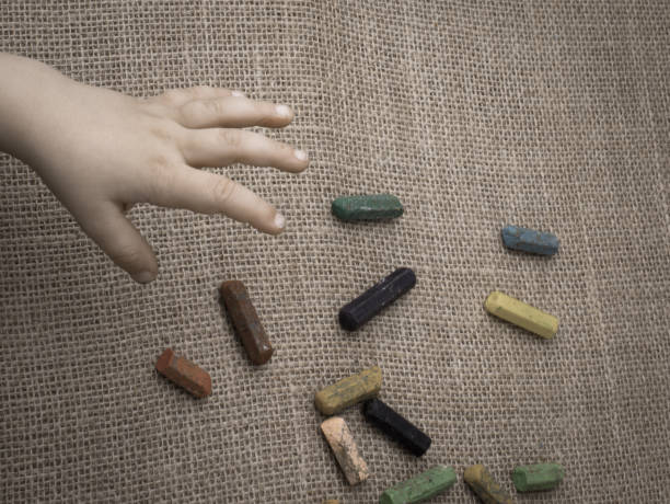 istock Used  color crayons and a toddlers hand 1029345120