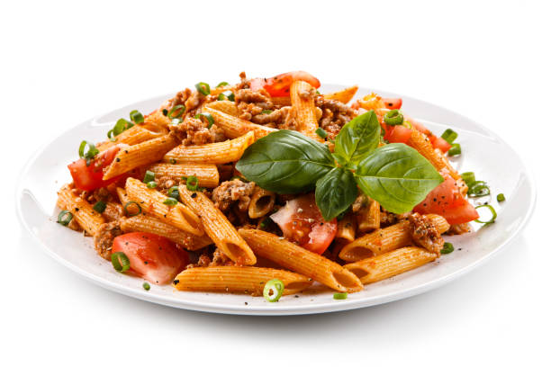 Pasta with meat, tomato sauce and vegetables Pasta with meat, tomato sauce and vegetables on white background main course stock pictures, royalty-free photos & images