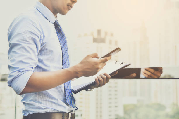 istock Midsection Of Businessman Using Mobile Phone In Office 1029350472