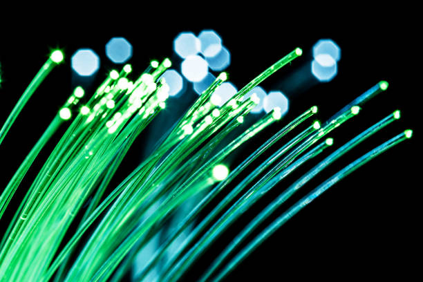 istock Bundle of optical fibers with green light. 1029350926