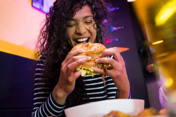 istock Women eating a hamburger 1029351084