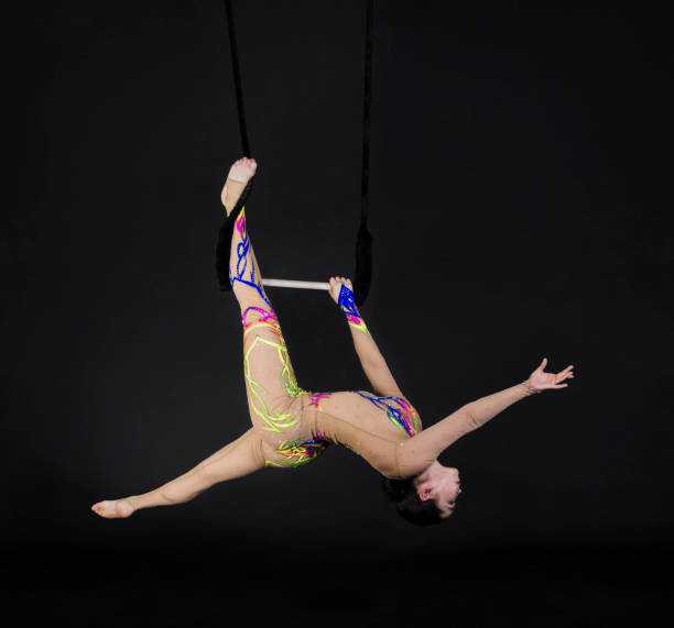 istock A young girl performs the acrobatic elements in the air trapeze. 1029361938