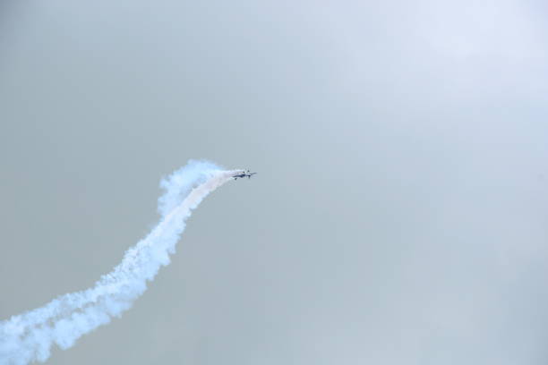 istock A plane flying upside down while at the same time emitting a lot of smoke from behind seen during a stormy summer day in Poland 1029366760