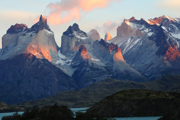 Torres del Paine national park in Patagonia Andes, Chile. South America mountain landscape. Beautiful mountains Torres del Paine on sunny day with clear sky at sunrise. Dawn at Torres del Paine towers