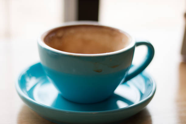 istock Empty cup of Latte coffee with stains on the wooden table 1029369986