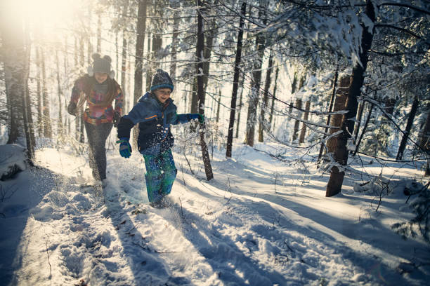 istock Brother and sister enjoying winter forest 1029378114