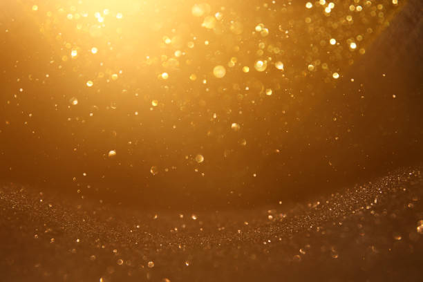 istock glitter vintage lights background. black and gold. de-focused. 1029386062