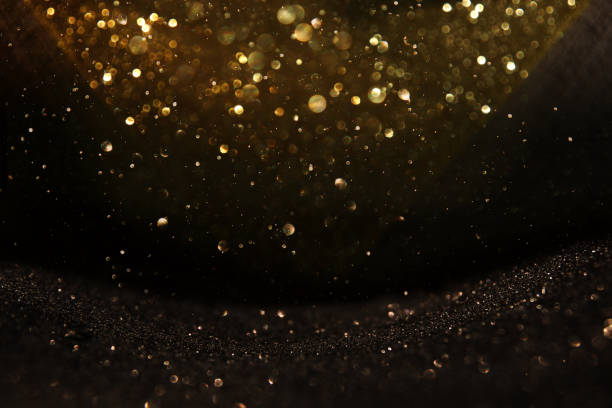istock glitter vintage lights background. black and gold. de-focused. 1029386064