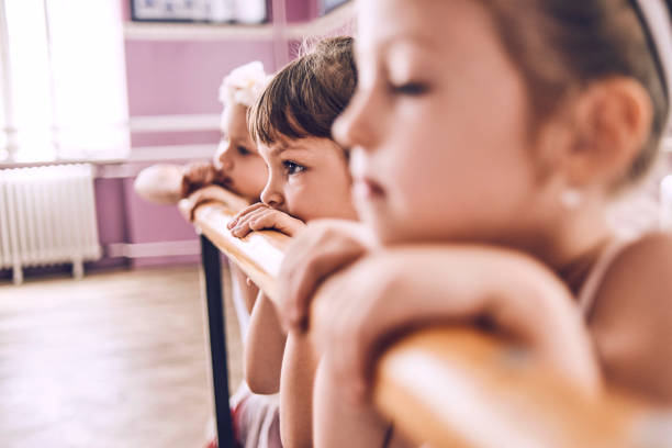 group of ballerinas relaxing after ballet class - round bale imagens e fotografias de stock